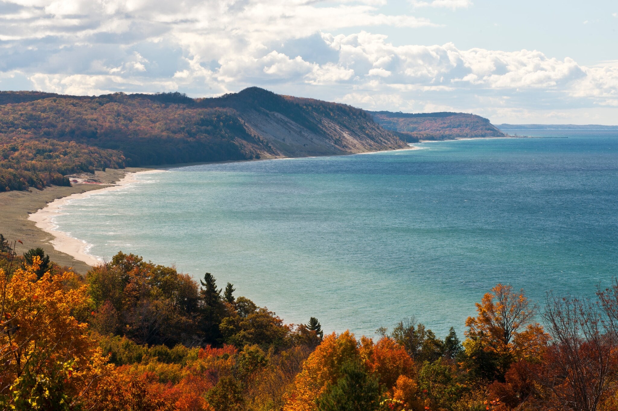 Blick auf die Küste des Michigansees am Ufer des Naturreservats Green Point Dunes mit herbstlich bunten Bäumen. Blick auf die Küste des Michigansees am Ufer des Naturreservats Green Point Dunes mit herbstlich bunten Bäumen.