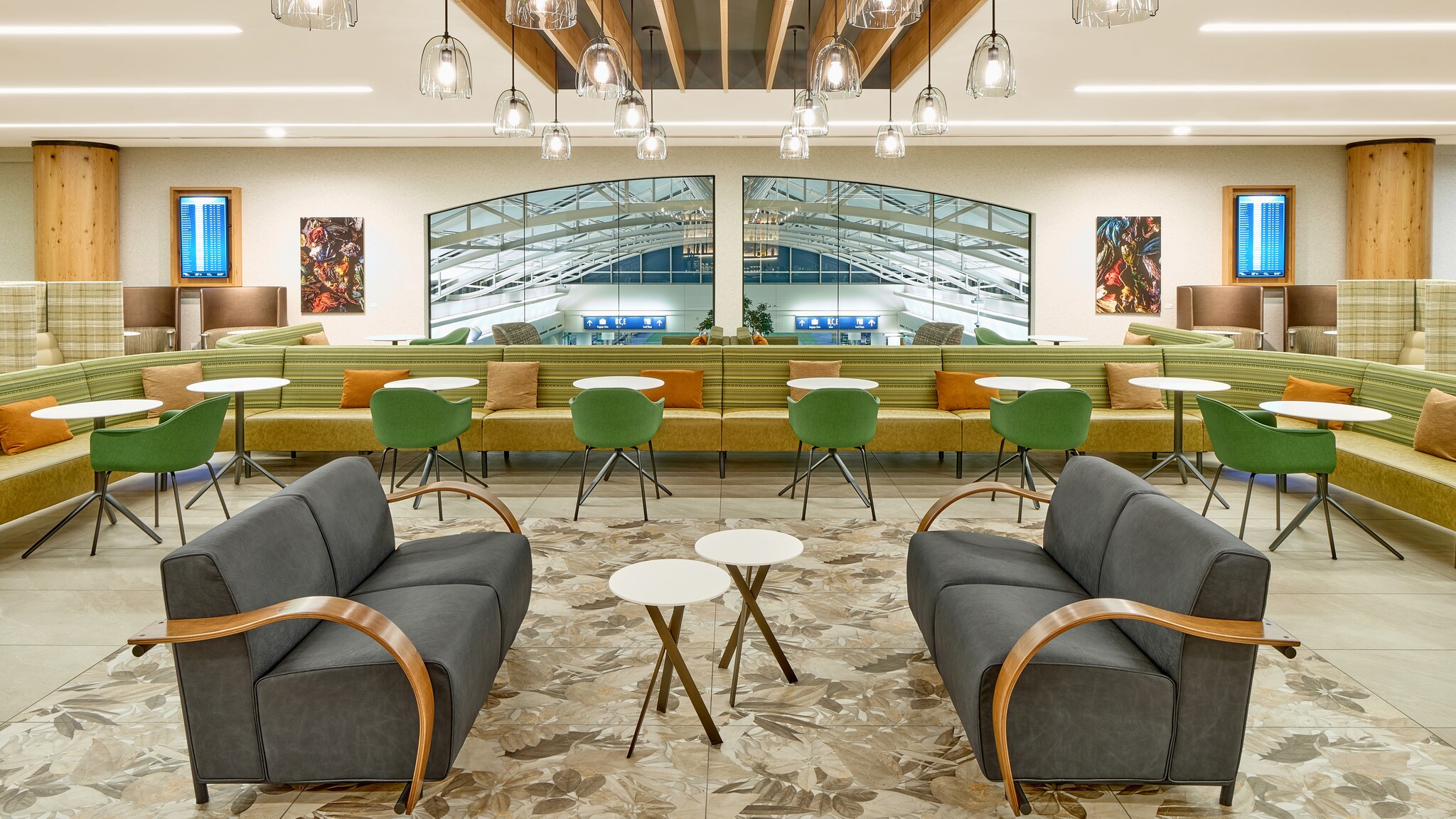 Moderne, elegante Flughafen-Lounge mit unterschiedlichen Sitzgelegenheiten und einem Panoramafenster mit Blick in den Terminal.