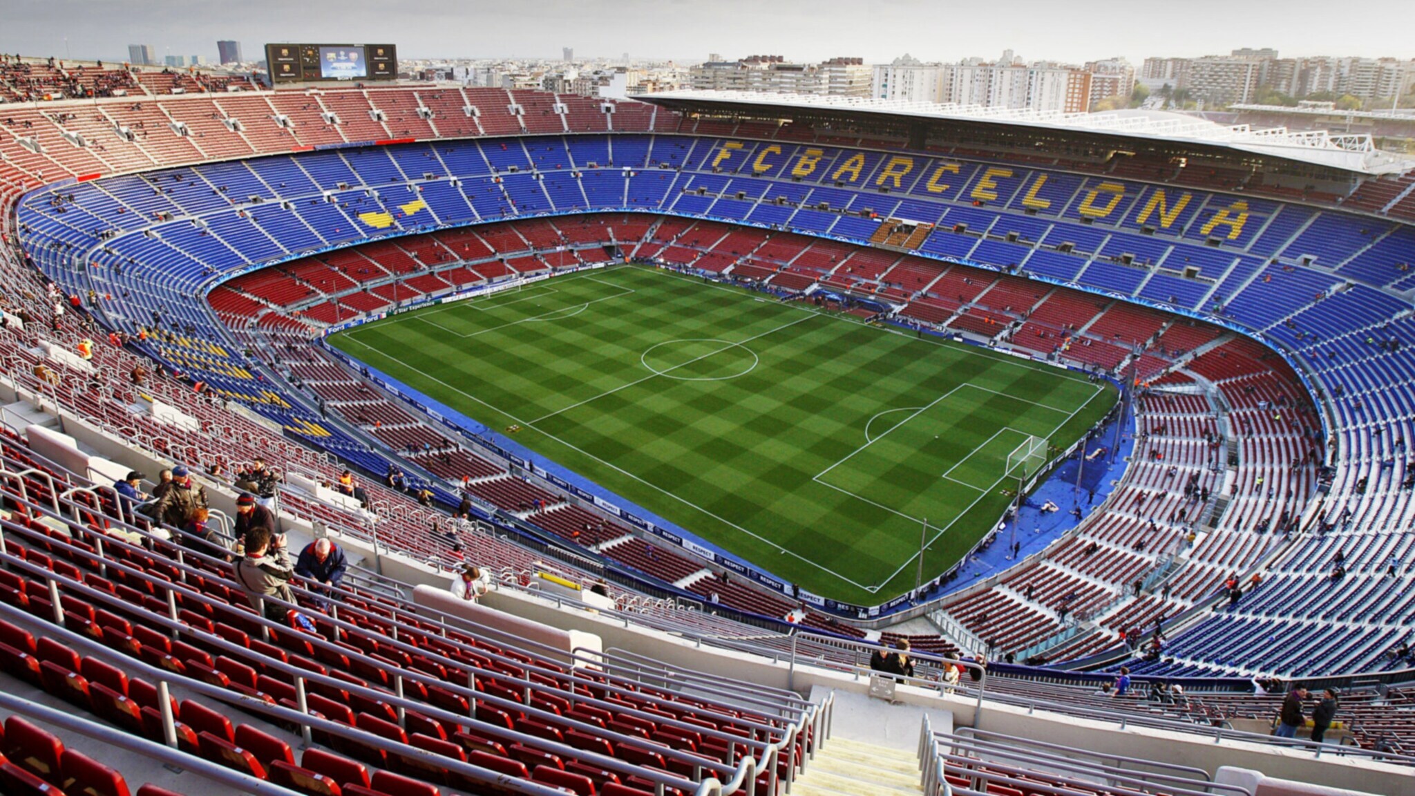 Vereinzelte Personen in einem Fußballstadion mit Aufschrift FC BARCELONA auf den Rängen. Vereinzelte Personen in einem Fußballstadion mit Aufschrift FC BARCELONA auf den Rängen.