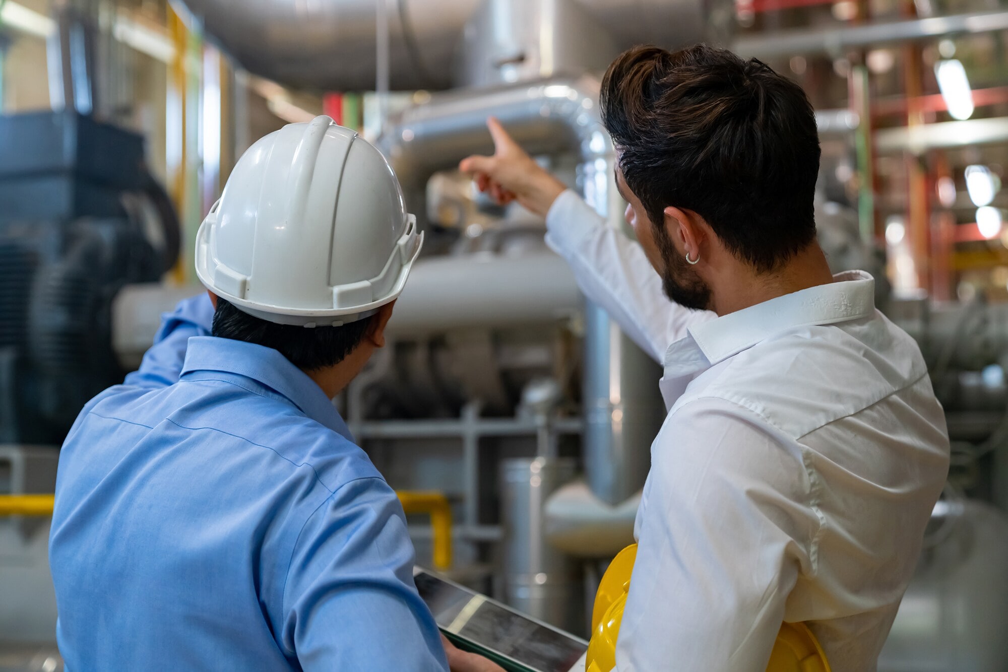 Professional male electrical engineer in safety uniform working