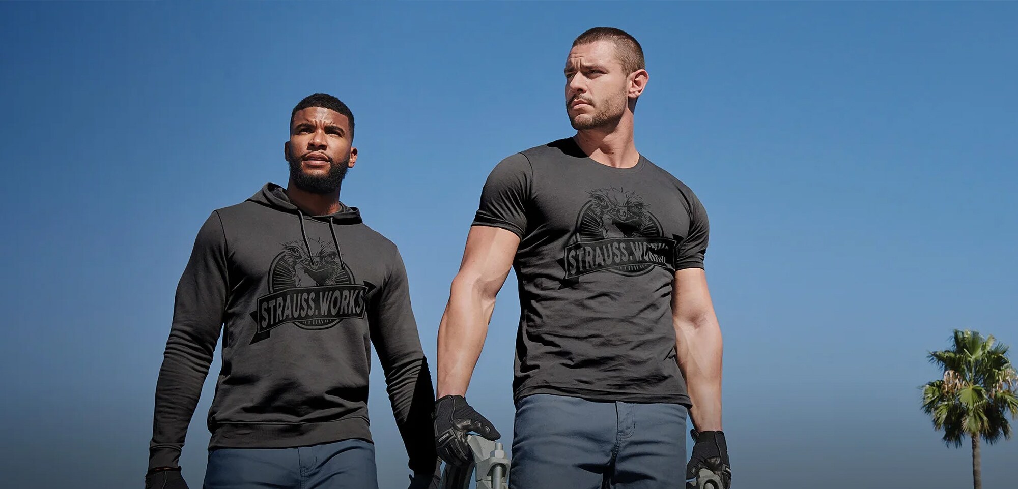 Engelbert Strauss: Vom Besenhersteller zum Workwear-Kult Zwei Männer in Arbeitskleidung tragen Werkzeuge zum Einsatzort.