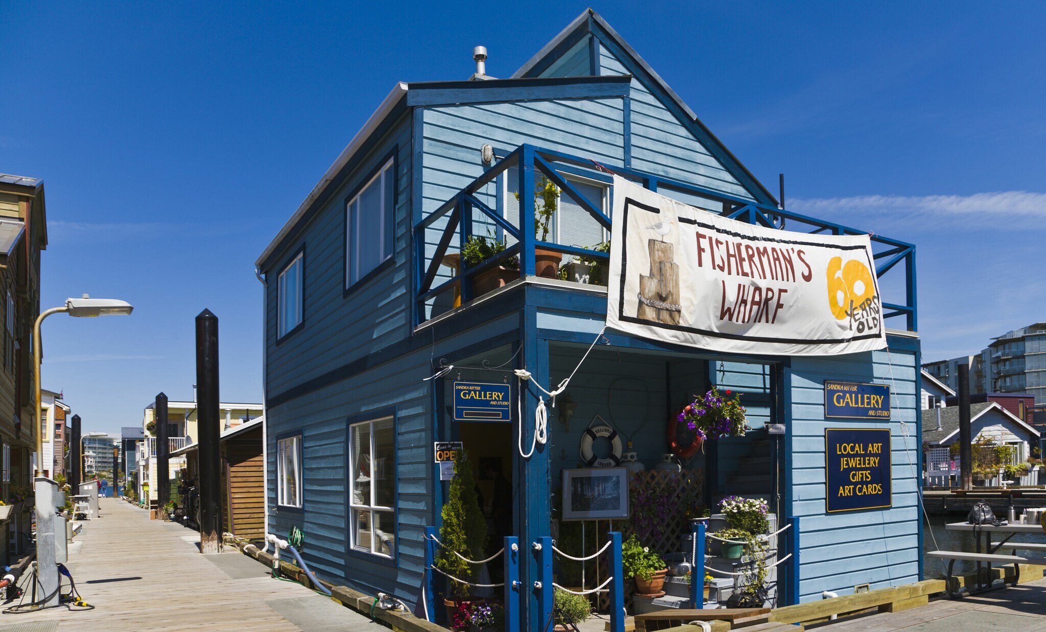 Hellblaues Holzhaus mit einer Galerie im Hafenviertel Fisherman’s Wharf. Hellblaues Holzhaus mit einer Galerie im Hafenviertel Fisherman’s Wharf.