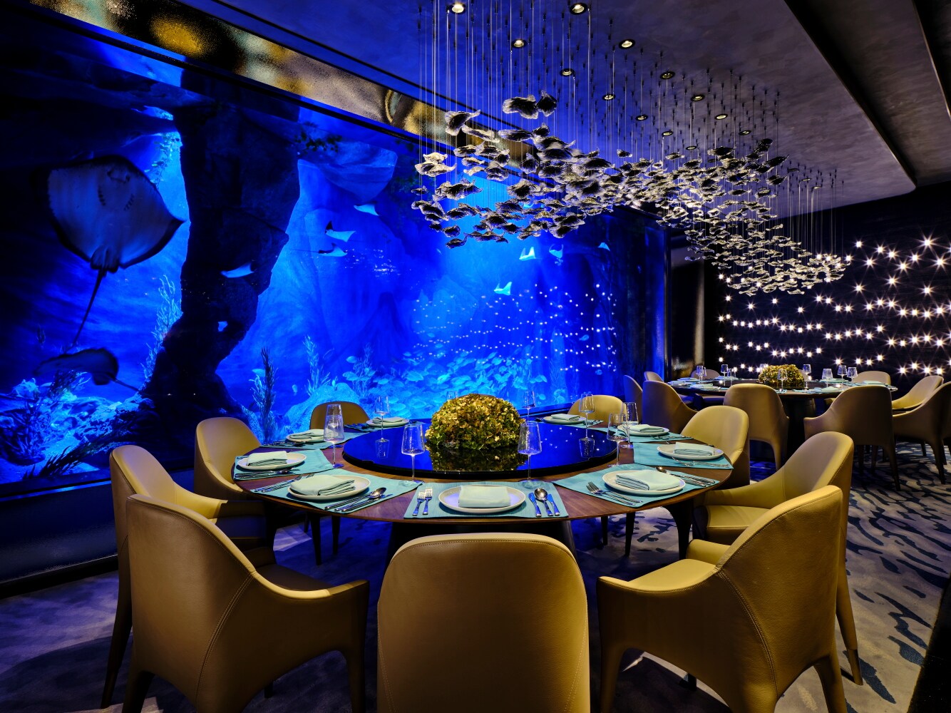 Schick gedeckter Tisch im Unterwasserrestaurant Mr.Fisher mit Blick auf die lebendige Aquariumwelt. Schick gedeckter Tisch im Unterwasserrestaurant Mr.Fisher mit Blick auf die lebendige Aquariumwelt.