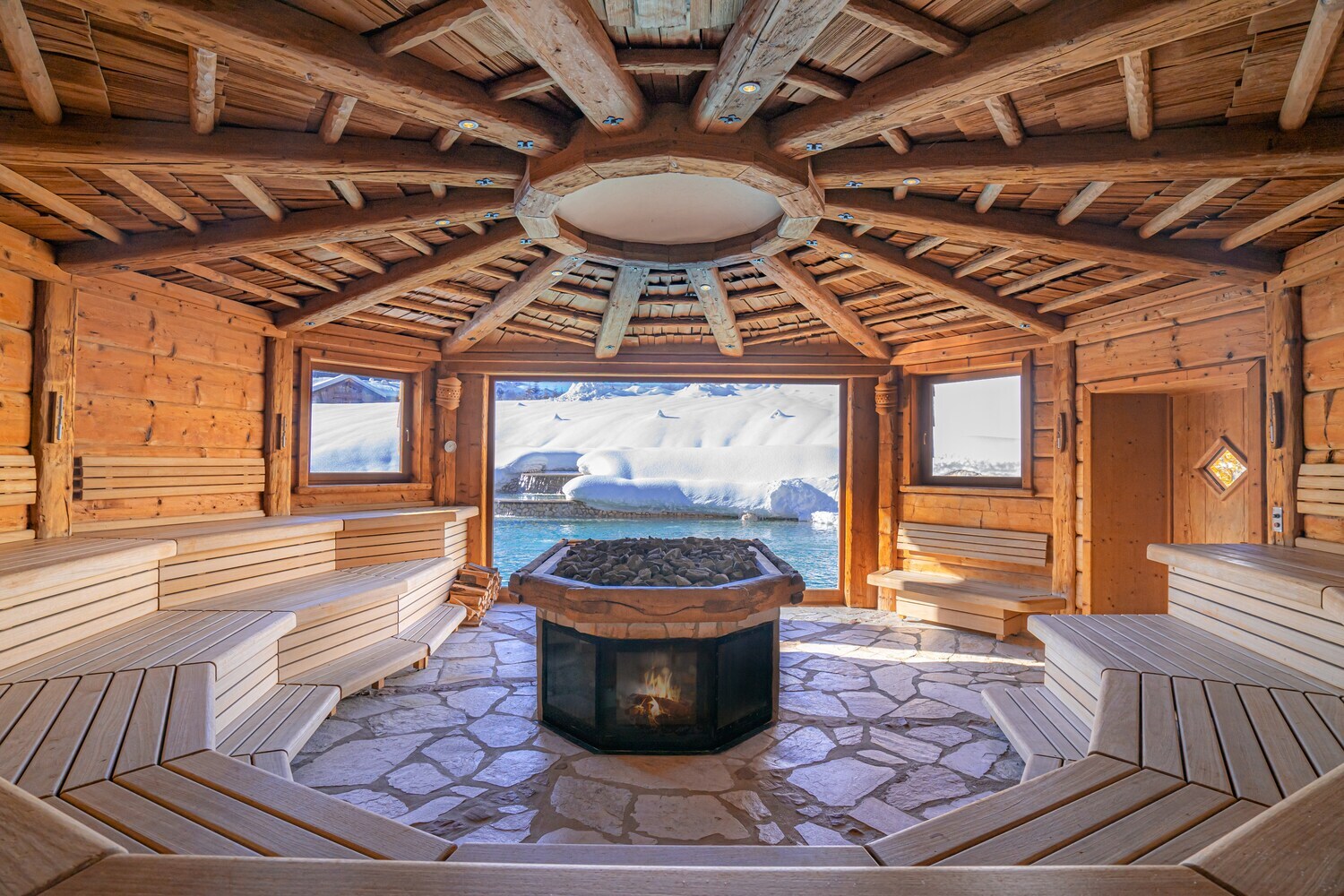 Innenaufnahme einer großen Sauna mit Ausblick in die winterliche Natur Innenaufnahme einer großen Sauna mit Ausblick in die winterliche Natur