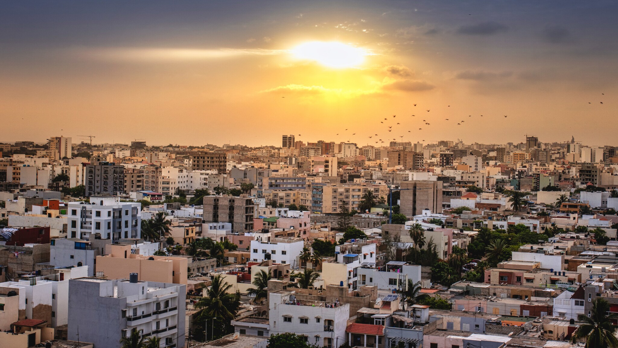 Skyline von Dakar mit hellen Gebäuden mit Flachdächern bei Sonnenuntergang. Skyline von Dakar mit hellen Gebäuden mit Flachdächern bei Sonnenuntergang.