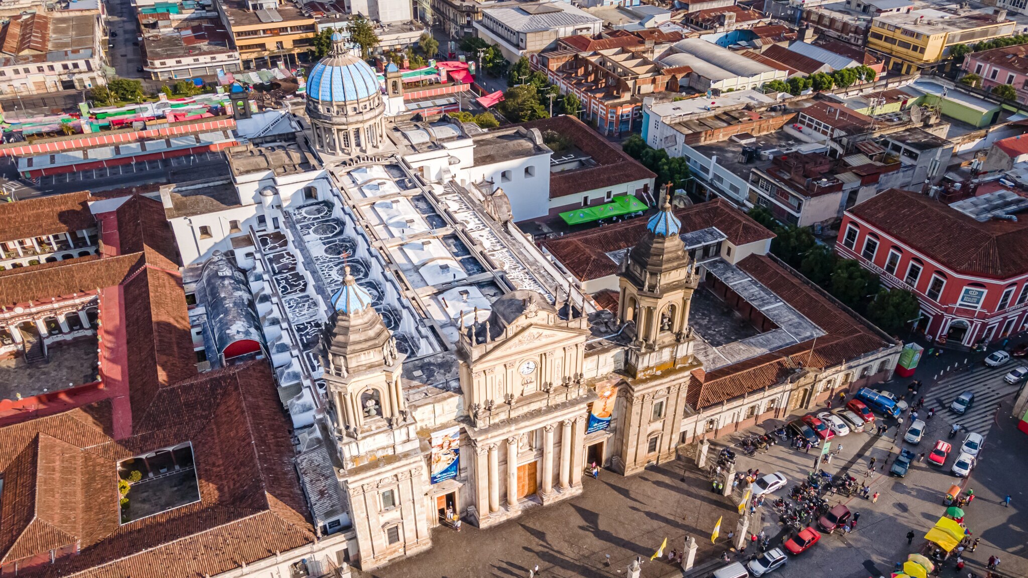 Luftaufnahme der Kathedrale von Guatemala-Stadt mit zwei Glockentürmen und blauem Kuppeldach im Stadtzentrum