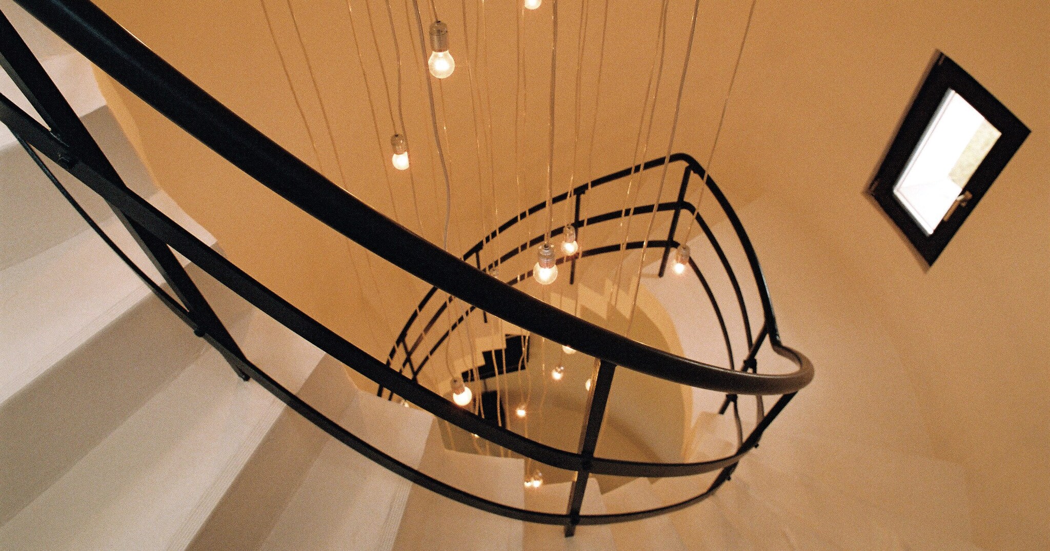 Eine stilvolle und enge weiße Wendeltreppe mit dunklem Geländer in einem Leuchtturm Eine stilvolle und enge weiße Wendeltreppe mit dunklem Geländer in einem Leuchtturm