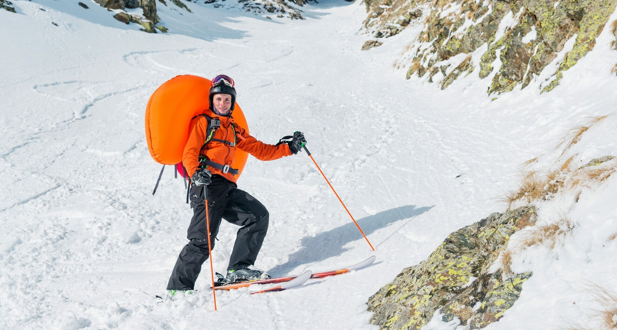 Ein Freerider mit einem geöffneten Lawinenrucksack.