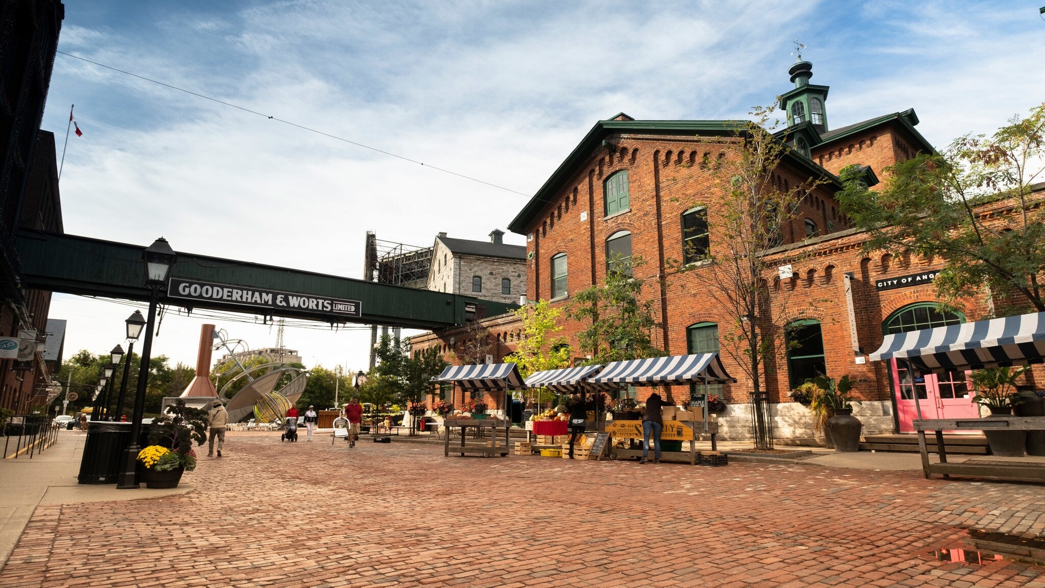 Historisches Industriegelände mit Backsteingebäude und Marktständen auf Kopfsteinpflaster. Historisches Industriegelände mit Backsteingebäude und Marktständen auf Kopfsteinpflaster.
