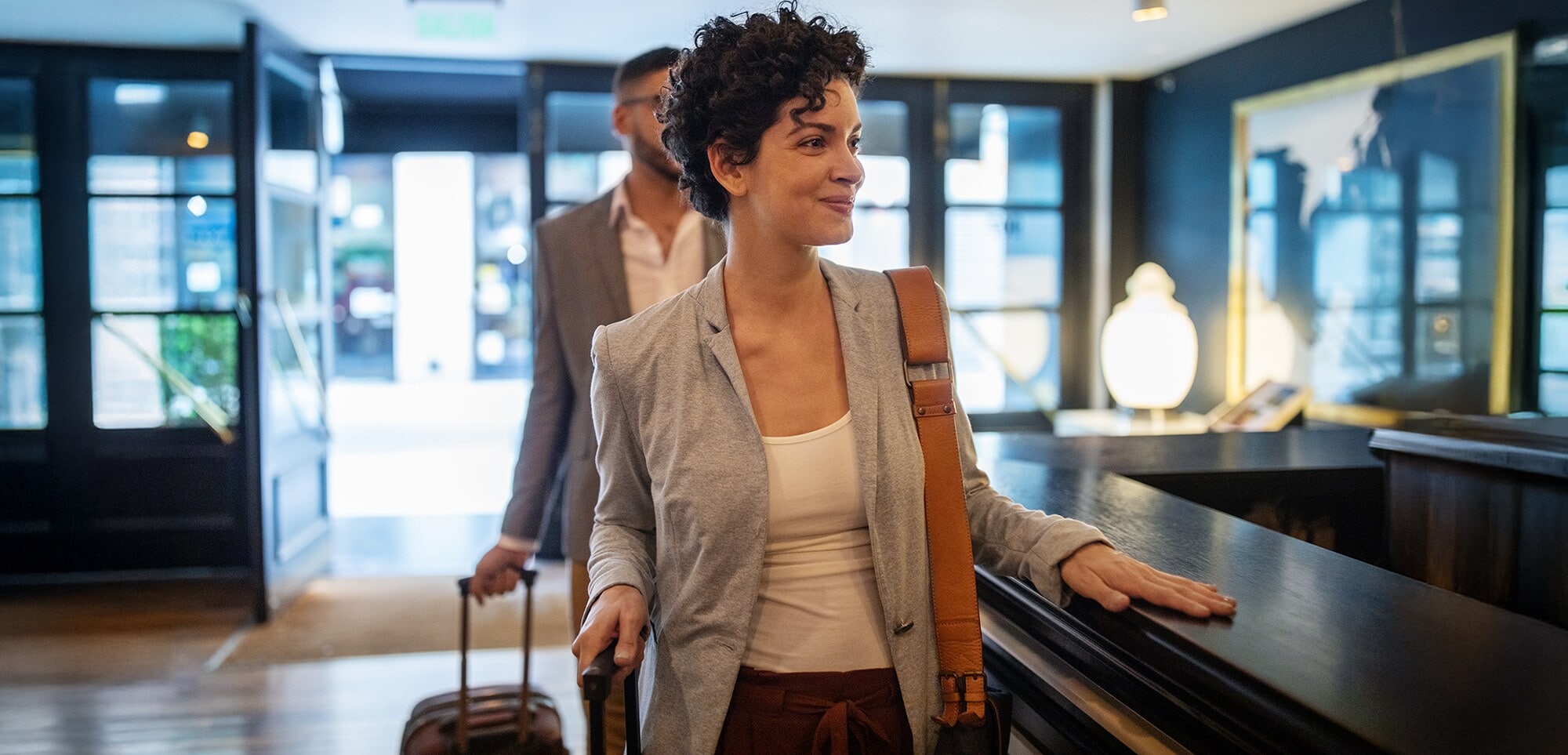 Hervorragend übernachten: Fine Hotels & Resorts Programm. Eine Geschäftsfrau steht an der Rezeption eines Hotels.