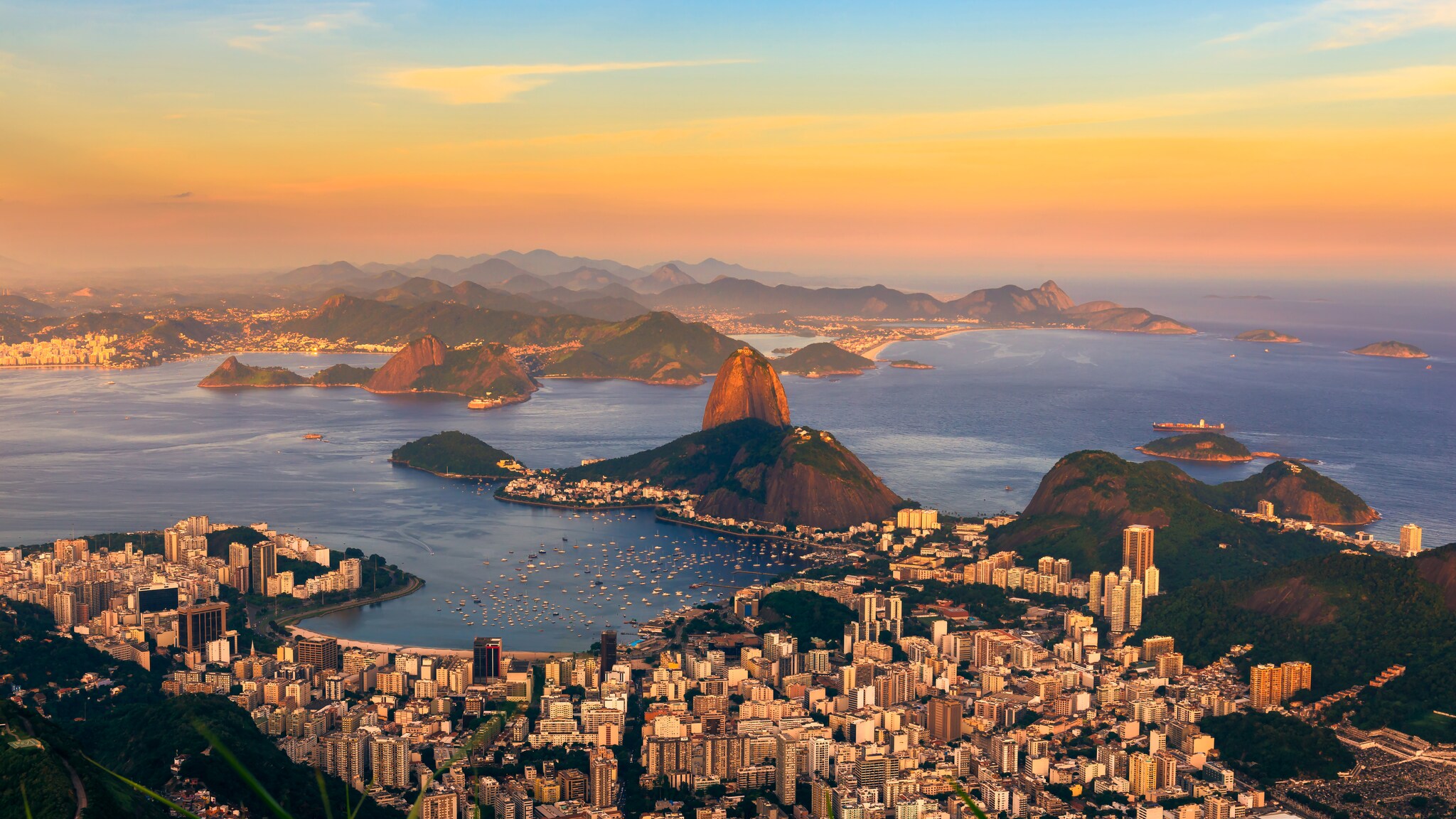 Eine große Stadt, die an einer Küste liegt mit einem Berg auf einer Insel.
