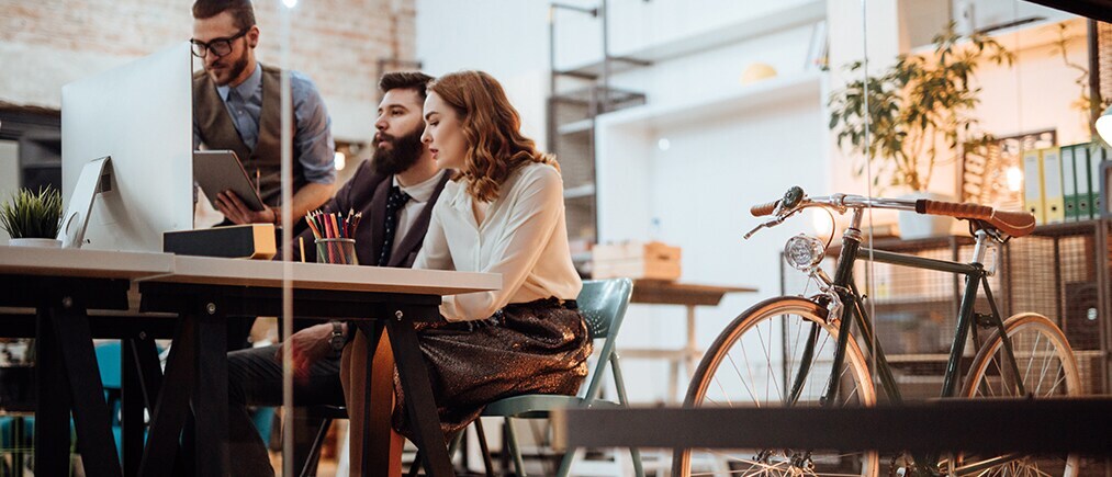 Blogbild: Junge Mitarbeitendeschauen zsm auf einen Bildschirm