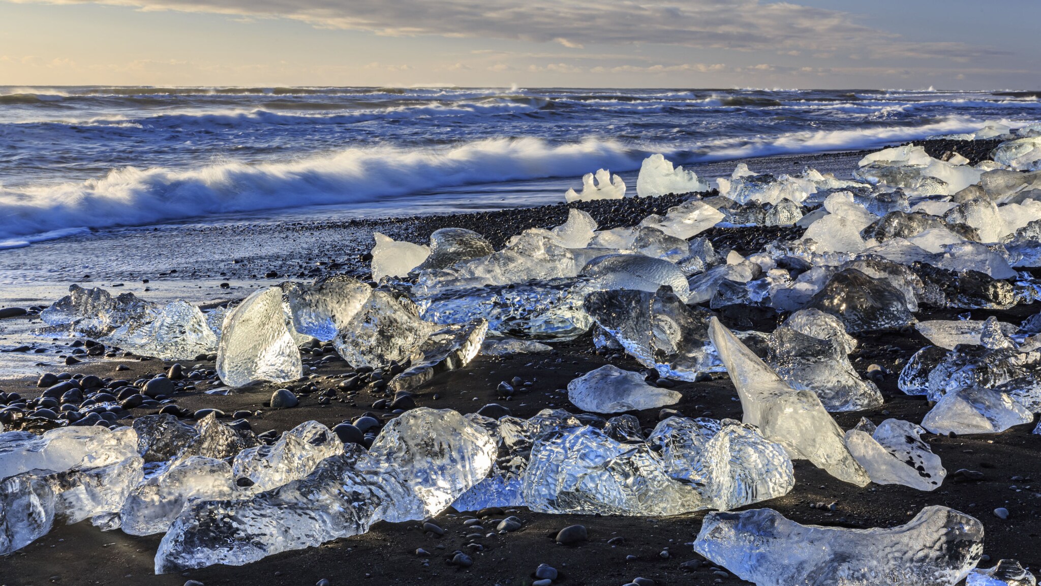 An einem kalten Wintermorgen funkeln die Eisbrocken am Diamaond Beach in der Sonne.