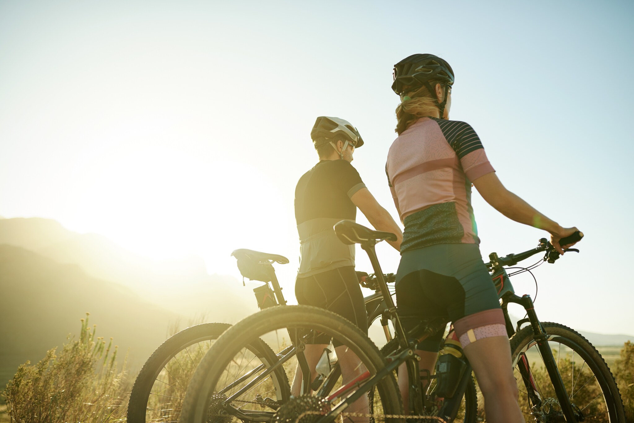 Ein Mann und eine Frau mit Mountainbikes genießen einen Ausblick