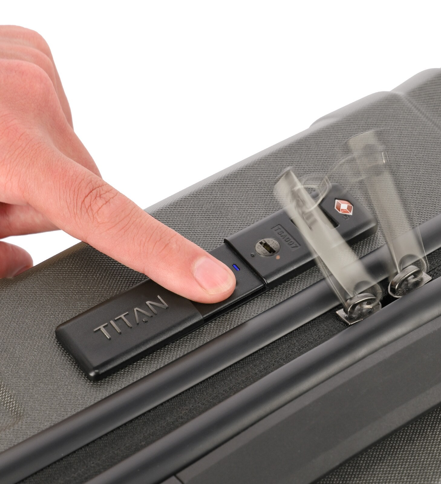 Ein Finger auf einem Scanner an einem Kofferschloss Ein Finger auf einem Scanner an einem Kofferschloss