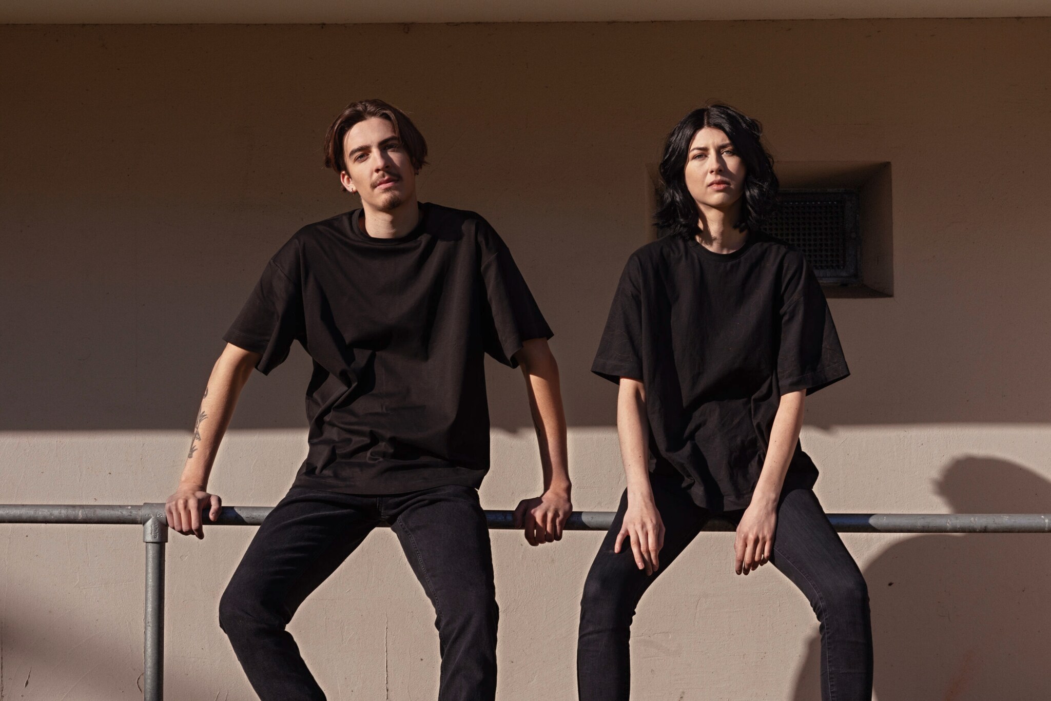 Ein Mann und eine Frau in schwarzer Kleidung auf einem Geländer