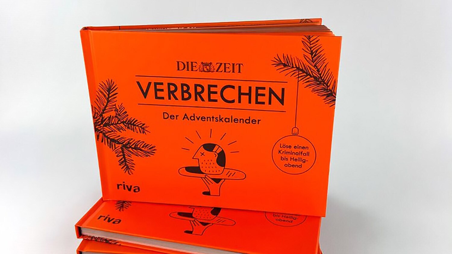 Vorderansicht eines orangefarbenen Adventskalenders in Form eines aufgeklappten Buches