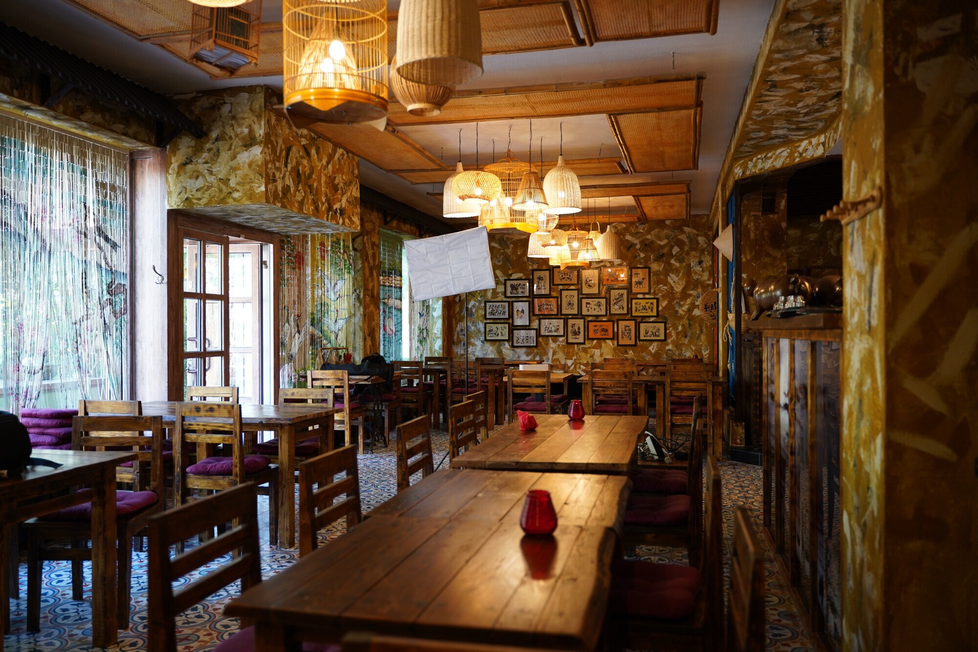 Innenraumaufnahme eines gemütlichn Restaurants mit Holztischen im vietnamesischen Stil