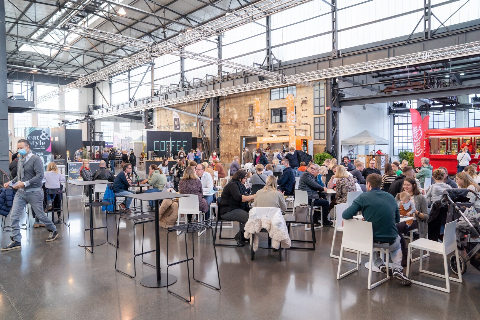 Messebesucher sitzen in GRuppen zusammen und essen Messebesucher sitzen in GRuppen zusammen und essen