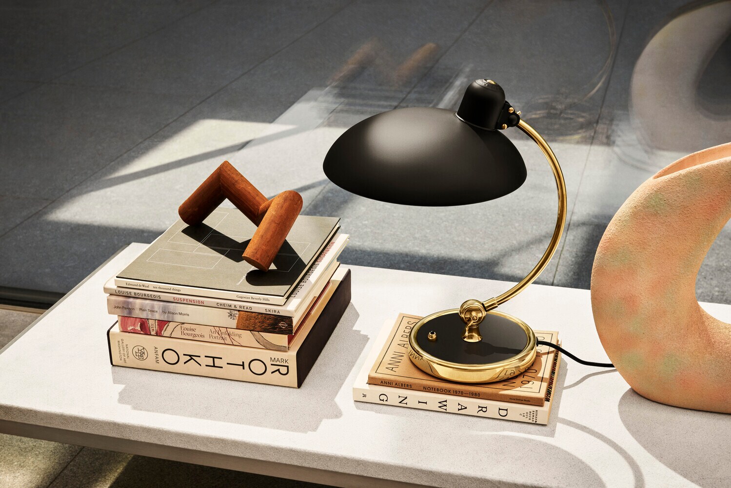 Die Lampe Kaiser Idell 6631 steht auf einem kleinen Tisch. Die Lampe Kaiser Idell 6631 steht auf einem kleinen Tisch.