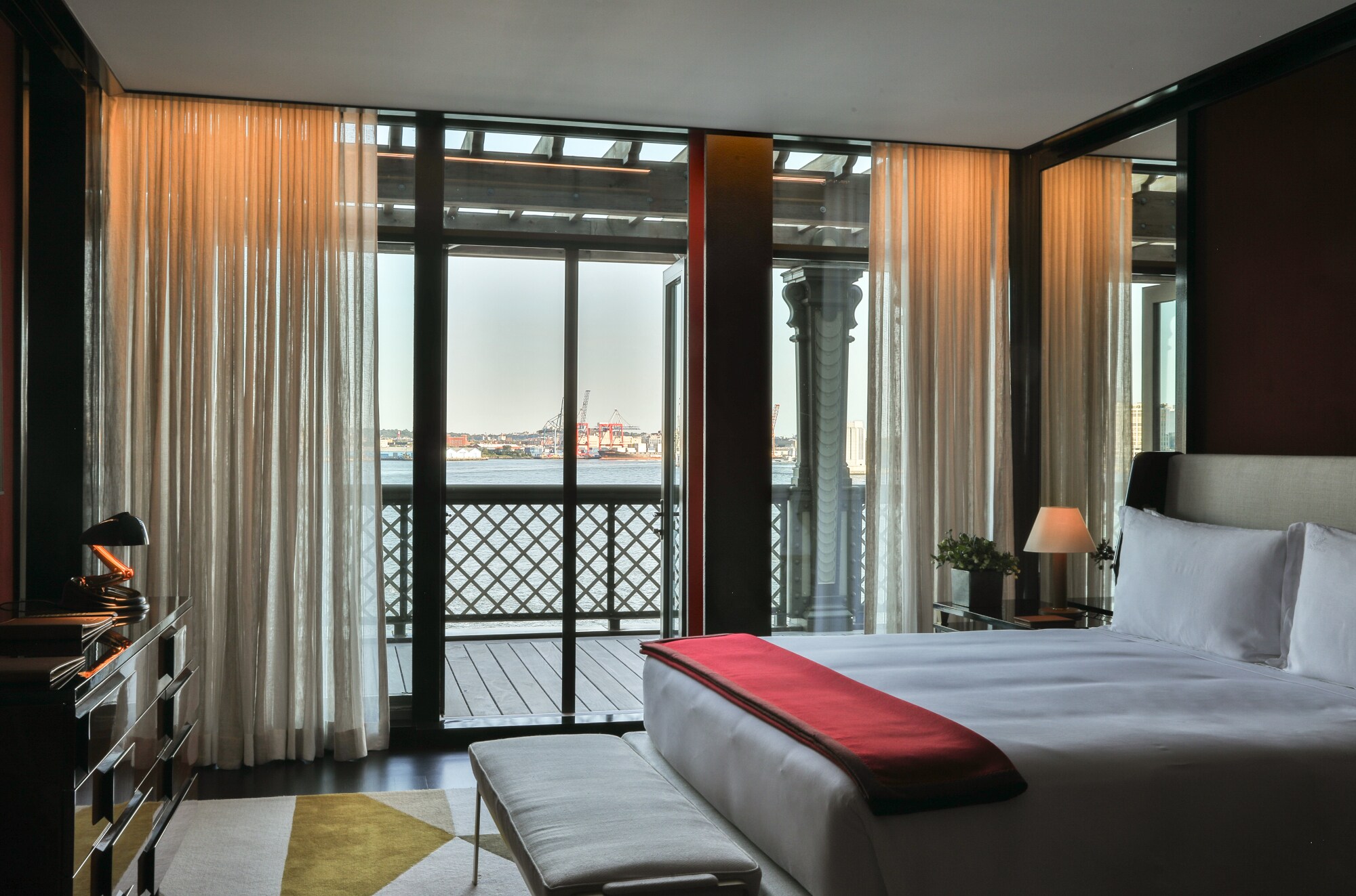 Hotelzimmer mit einem großen Fenster und hellen Vorhängen Hotelzimmer mit einem großen Fenster und hellen Vorhängen