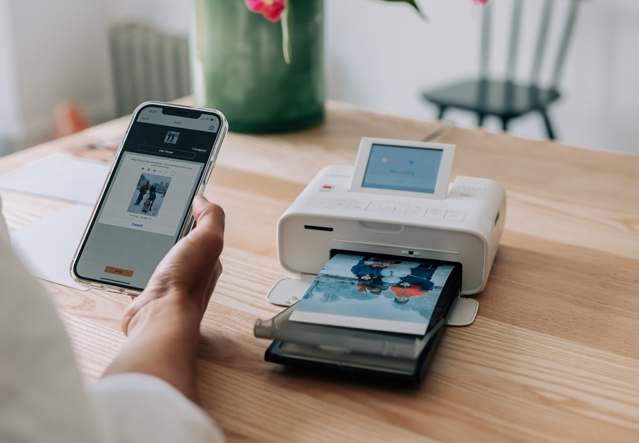 Ein Mini-Fotodrucker druckt ein Bild von einem Handy aus Ein Mini-Fotodrucker druckt ein Bild von einem Handy aus