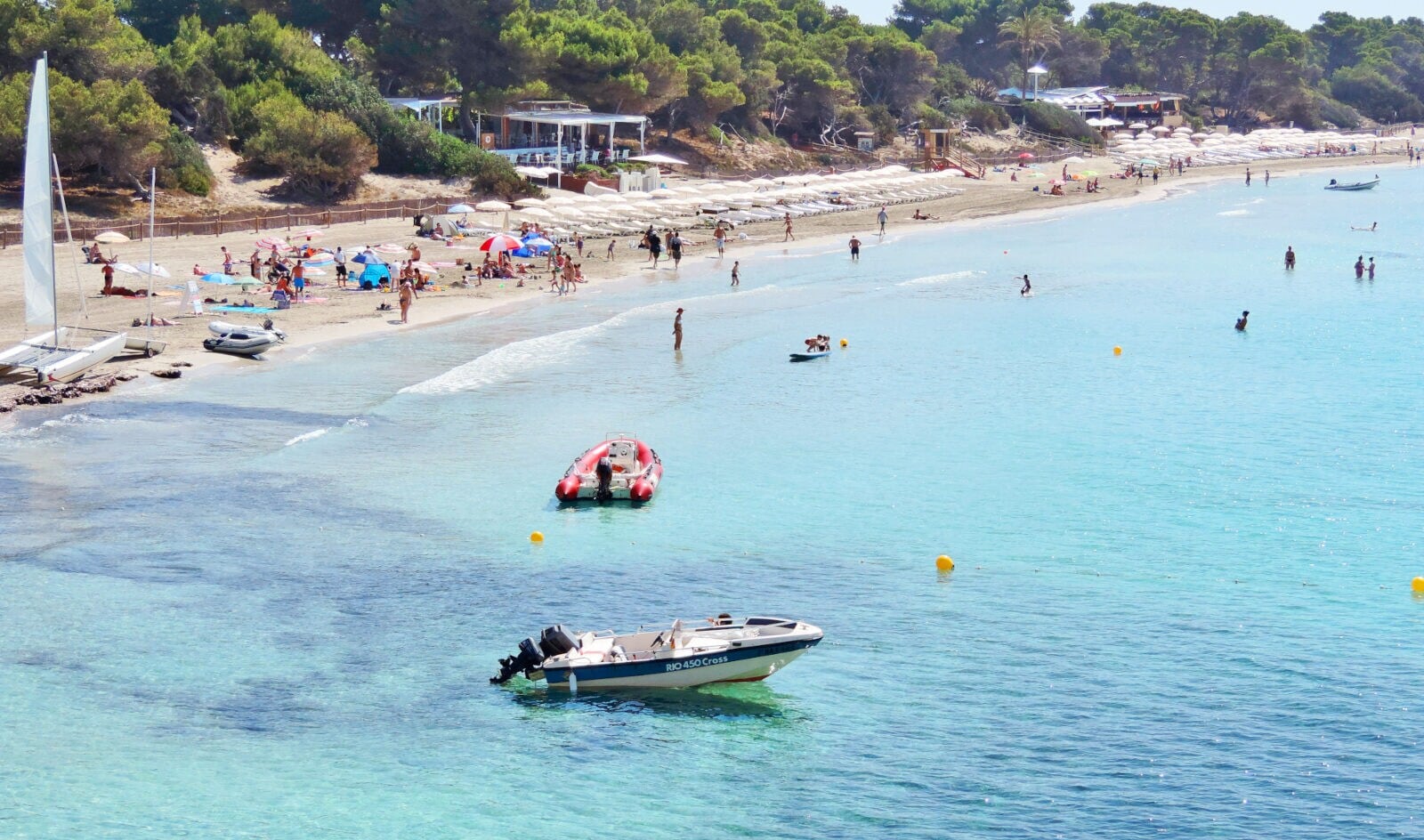 Ein Strand mit Booten im türkisblauen Wasser Ein Strand mit Booten im türkisblauen Wasser