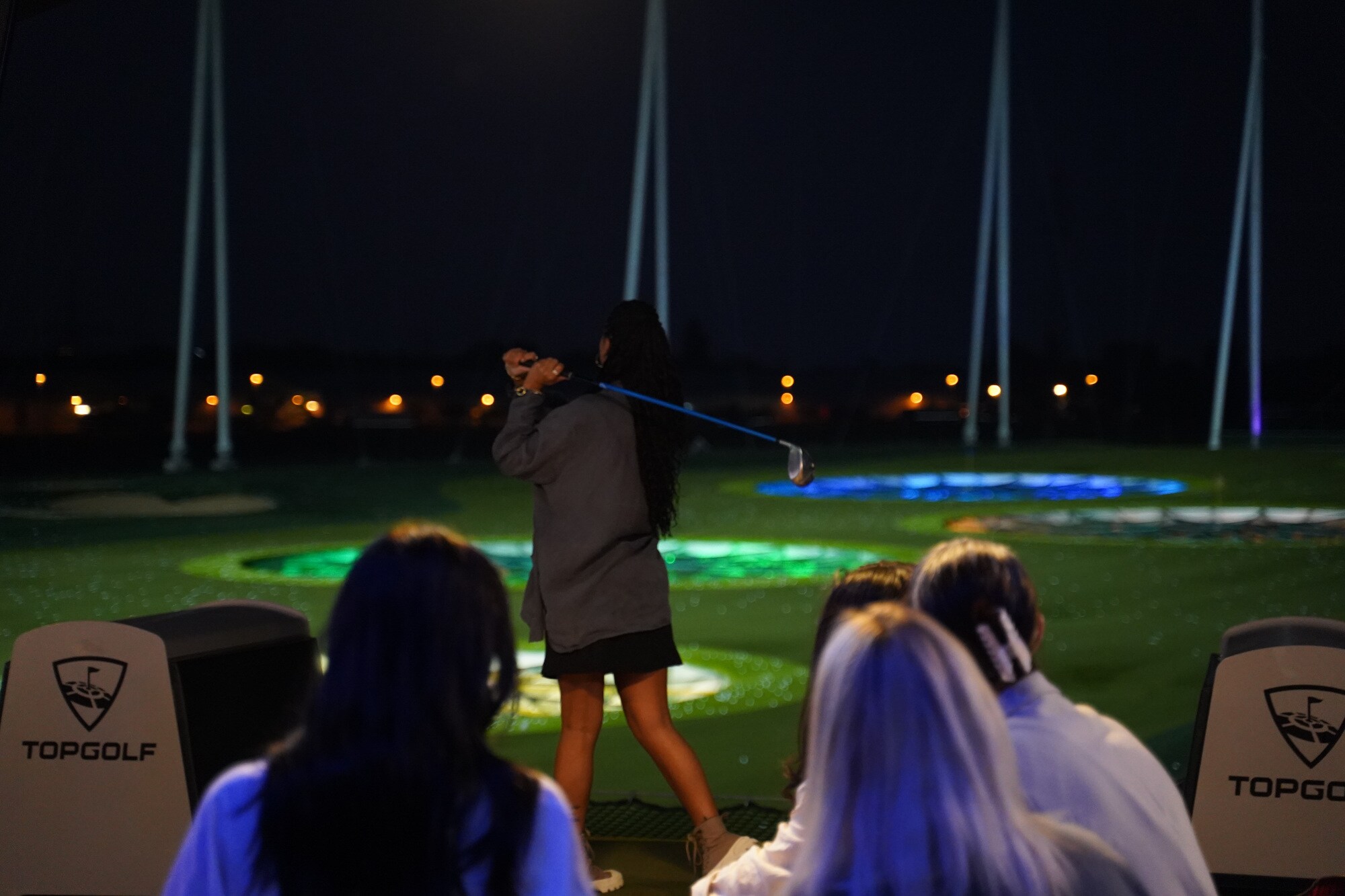 Eine Gruppe beim Golfen in der Nacht