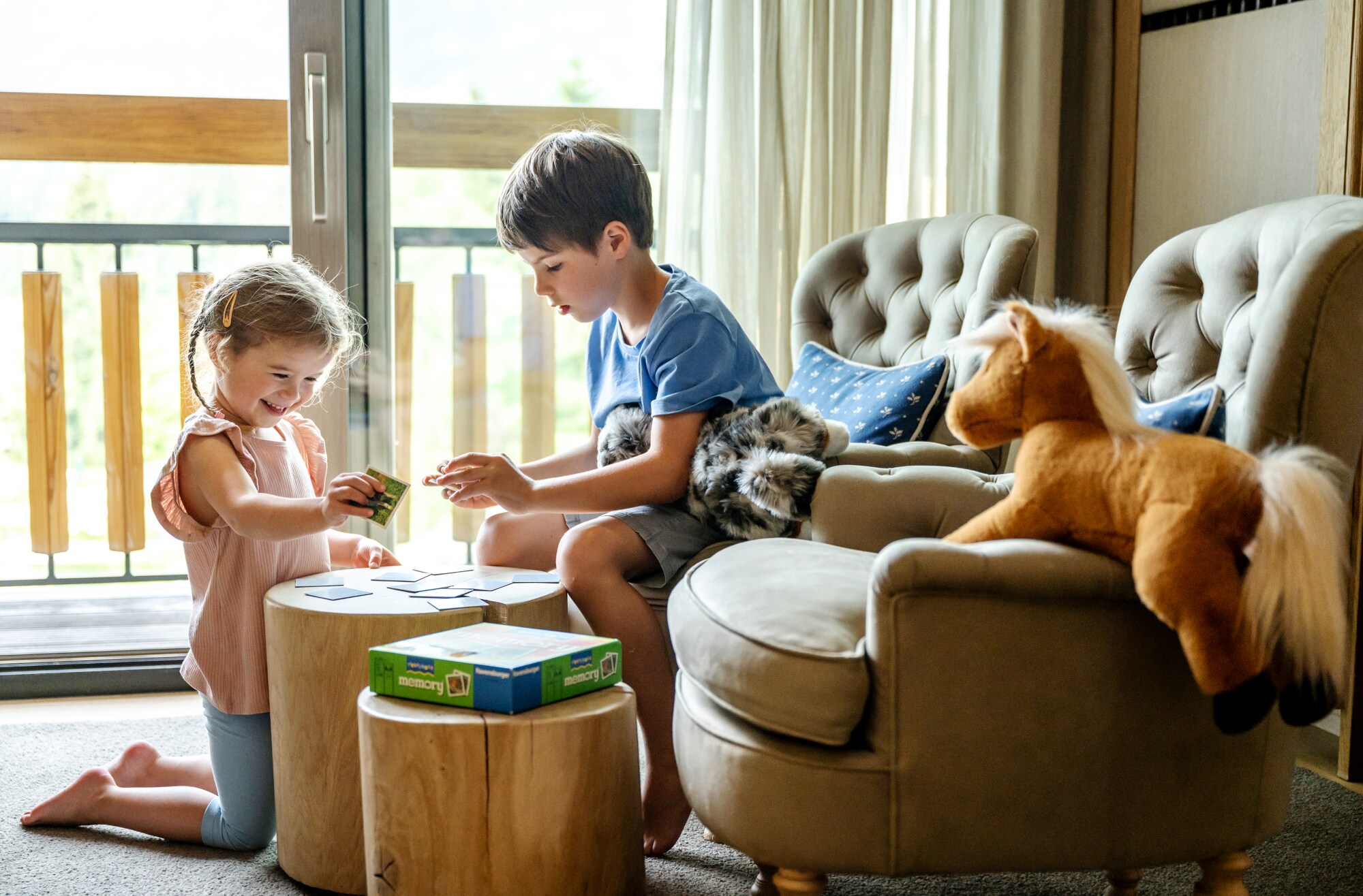 Zwei Kinder spielen in einem Hotelzimmer Memory