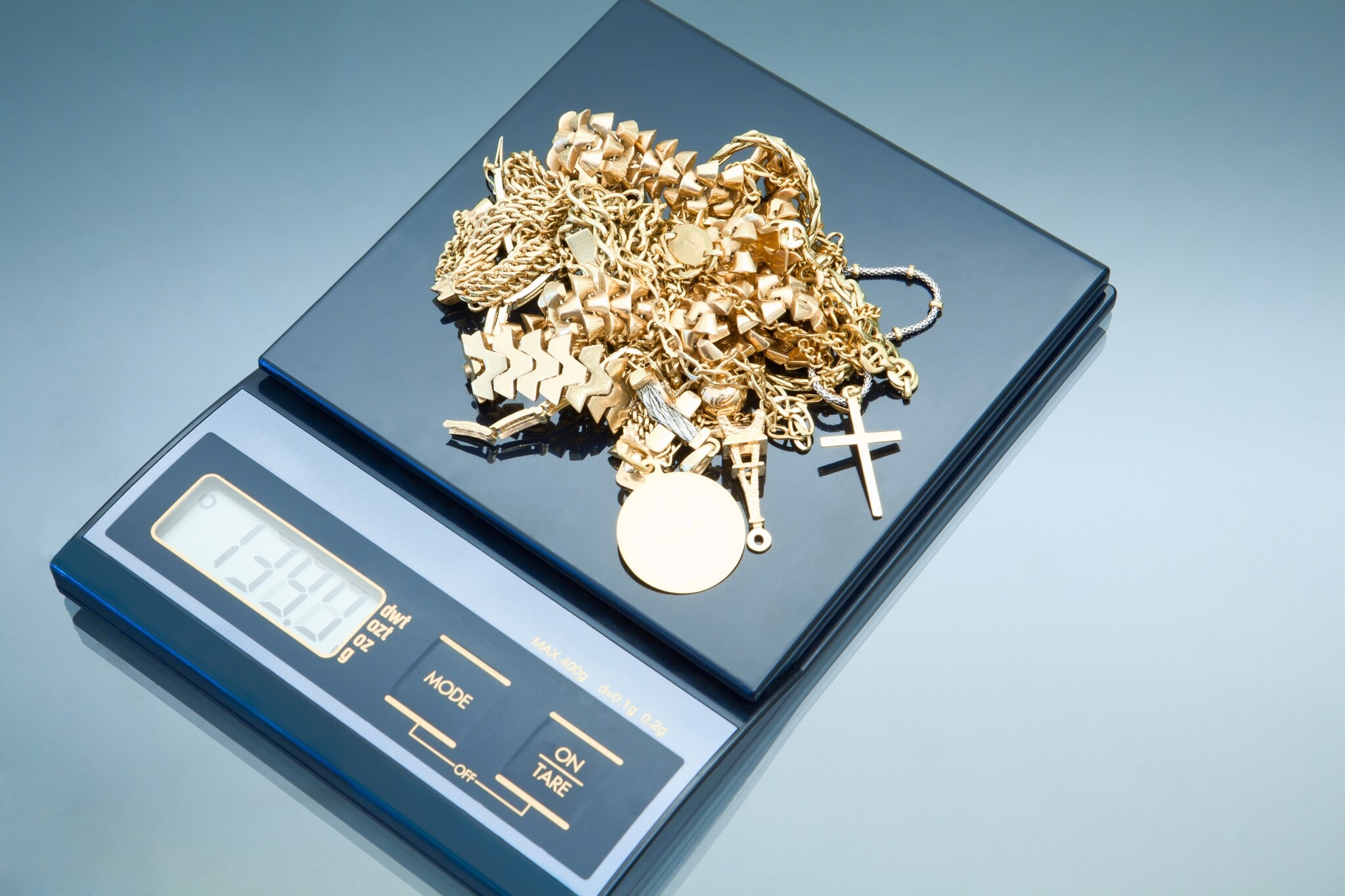 Gold wird auf einer elektronischen Waage gewogen Gold wird auf einer elektronischen Waage gewogen