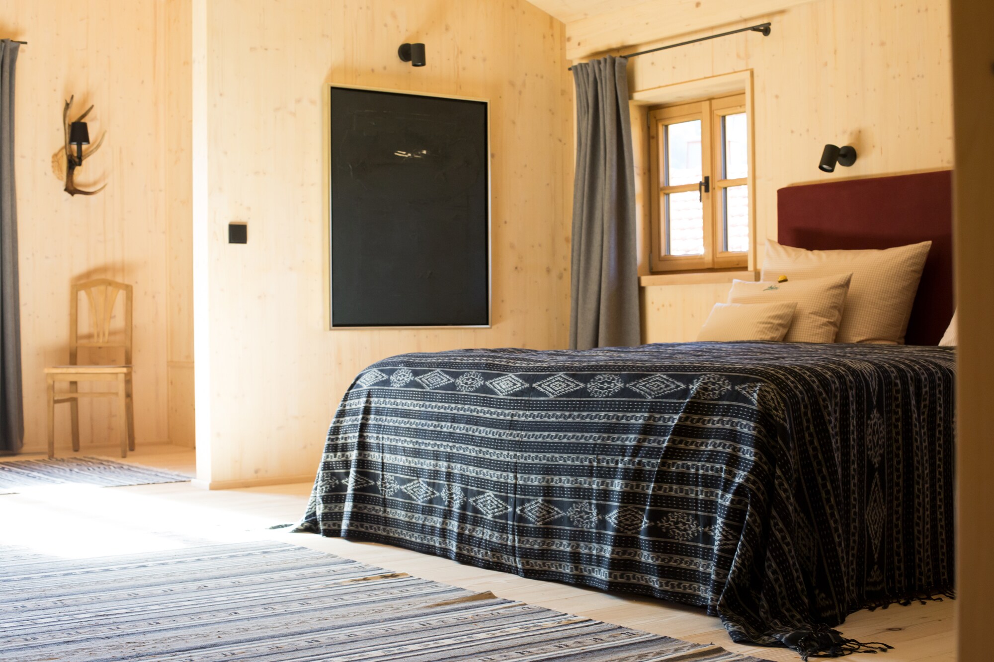 Holzverkleidetes Zimmer mit Doppelbett