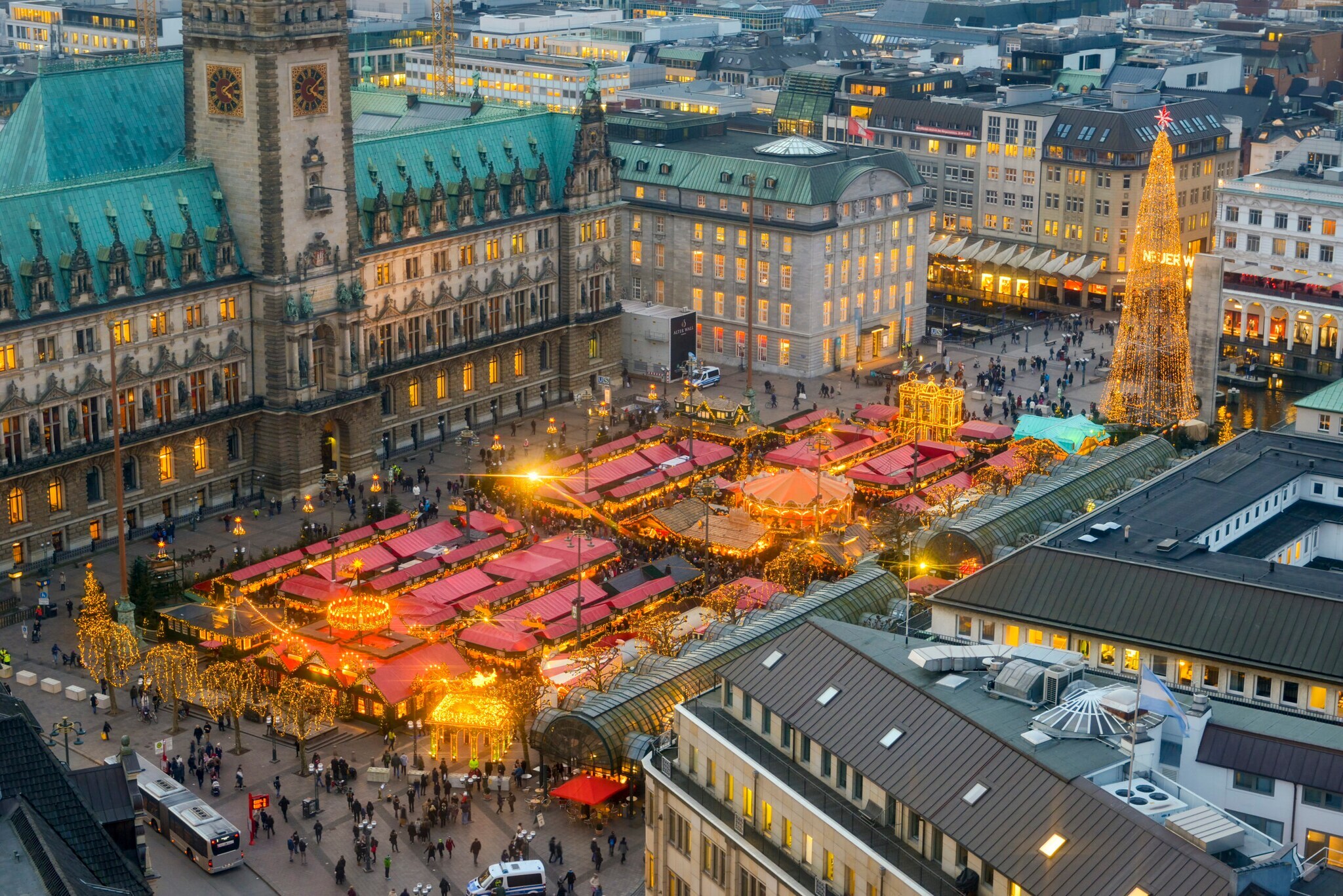 Luftaufnahme eines Weihnachtsmarktes vor dem Hamburger Rathaus bei Dämmerung