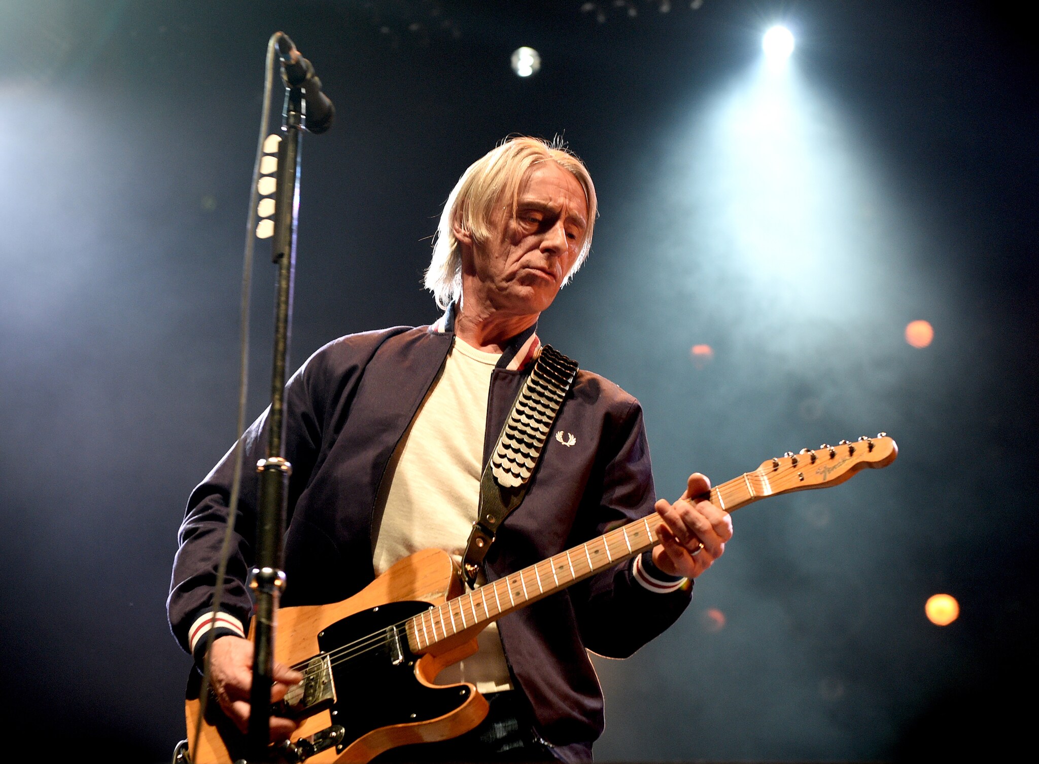 Nahaufnahme von Musiker Paul Weller mit einer Gitarre auf einer Bühne Nahaufnahme von Musiker Paul Weller mit einer Gitarre auf einer Bühne