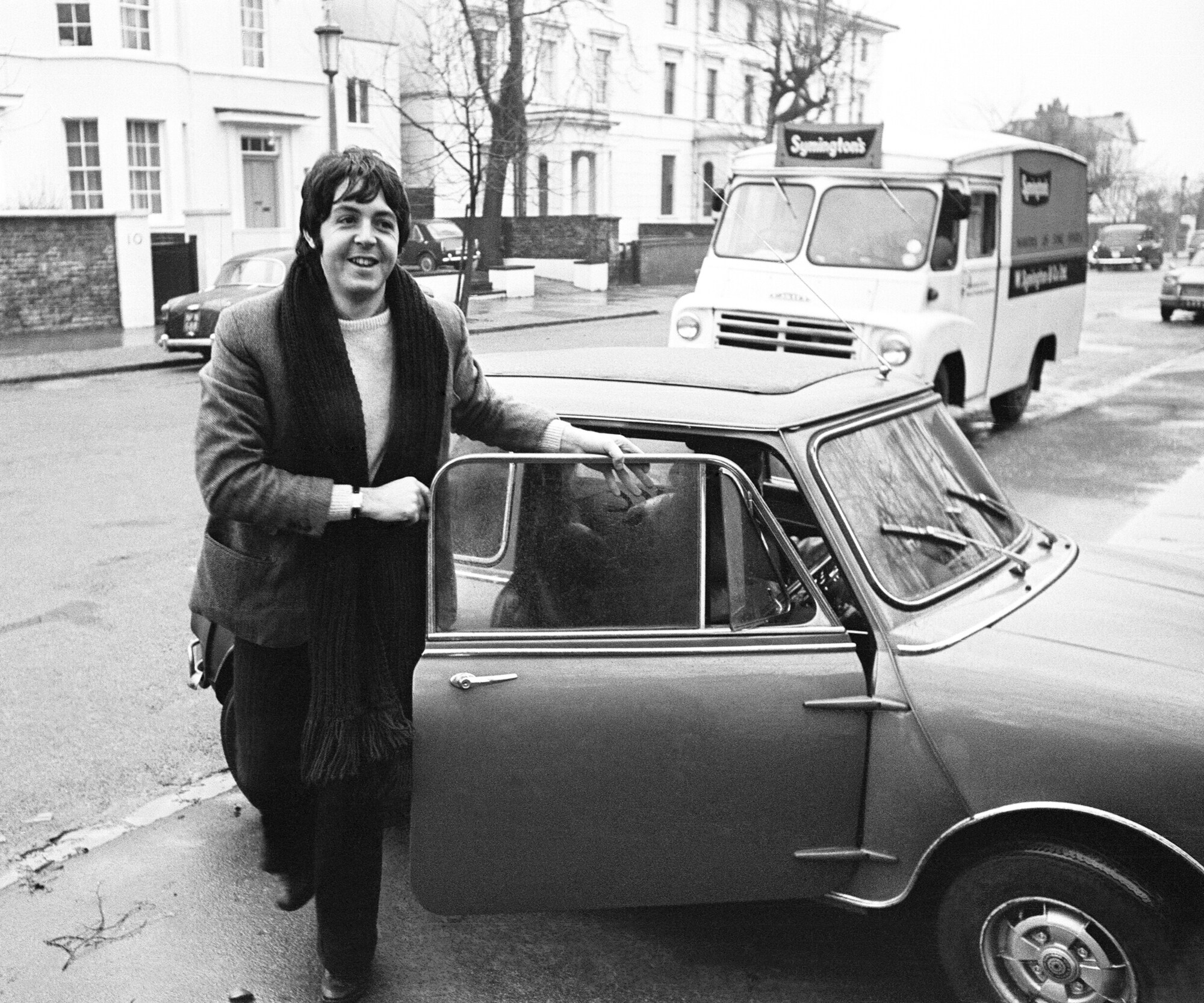 Ein historisches Foto von Musiker Paul McCartney mit seinem Mini-Modell Ein historisches Foto von Musiker Paul McCartney mit seinem MINI-Modell