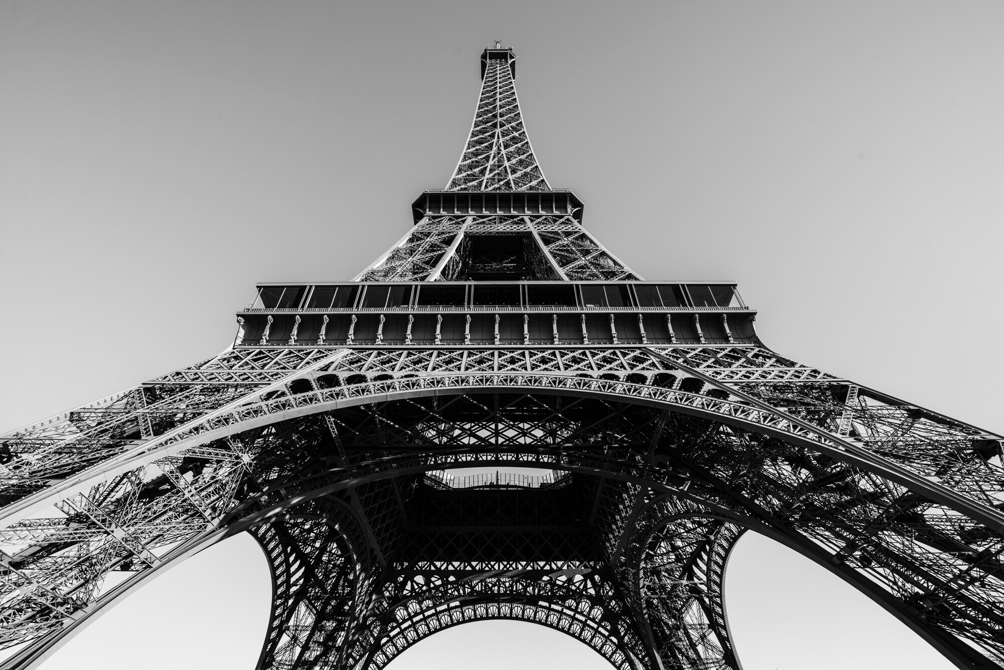 Schwarzweißaufnahme des Eiffelturms aus der Froschperspektive