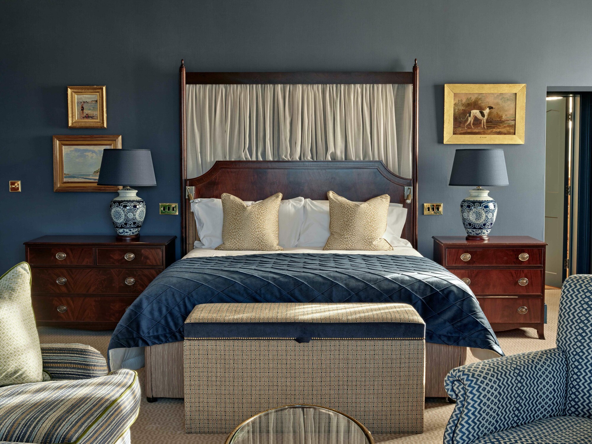 Ein nobles und gemütliches Hotelzimmer im britischen Stil mit blauen Accessoires Ein nobles und gemütliches Hotelzimmer im britischen Stil mit blauen Accessoires