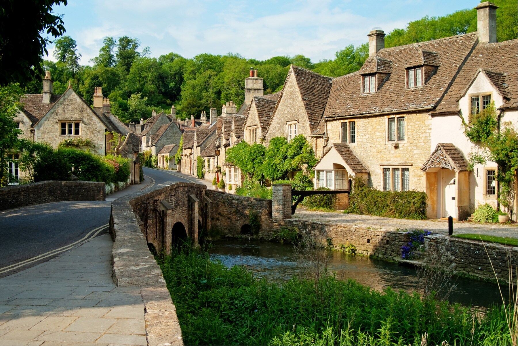 Kleines, englisches Dorf mit historischen Häusern aus Kalksandstein an einem Bachlauf Kleines, englisches Dorf mit historischen Häusern aus Kalksandstein an einem Bachlauf