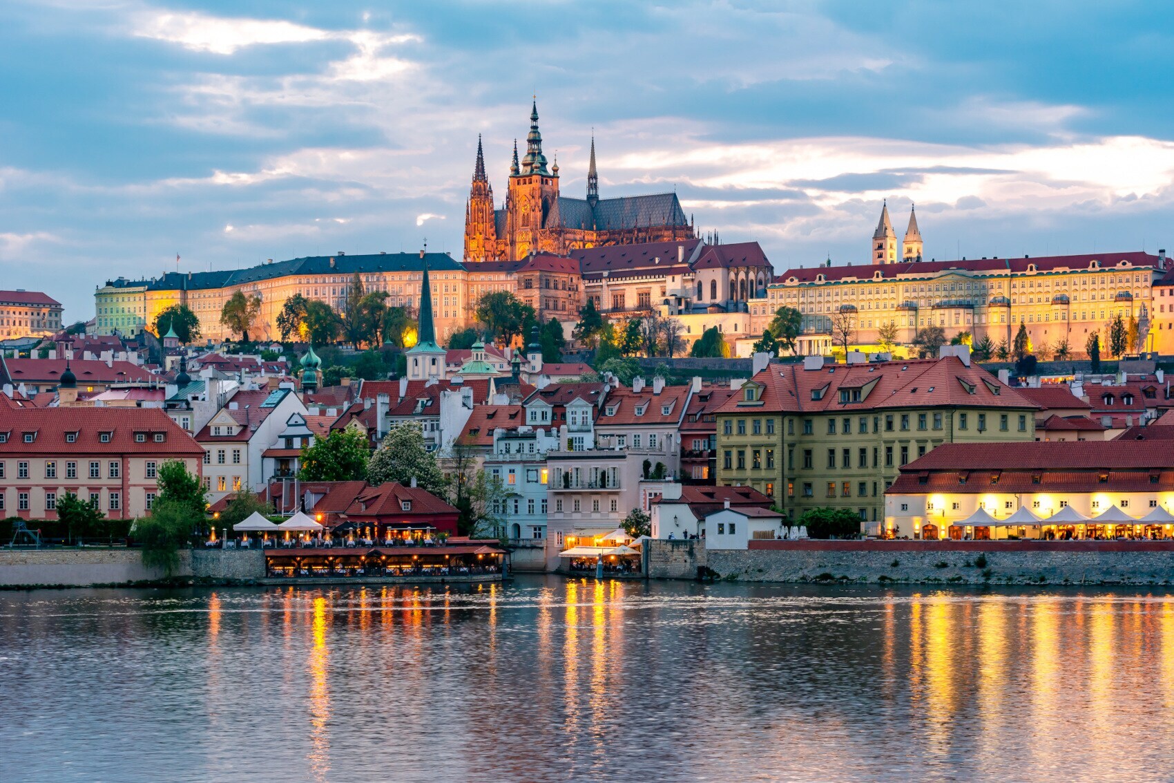 Stadtpanorama der Altstadt von Prag mit Burgkomplex auf einem Hügel, im Vordergrund Wasser
