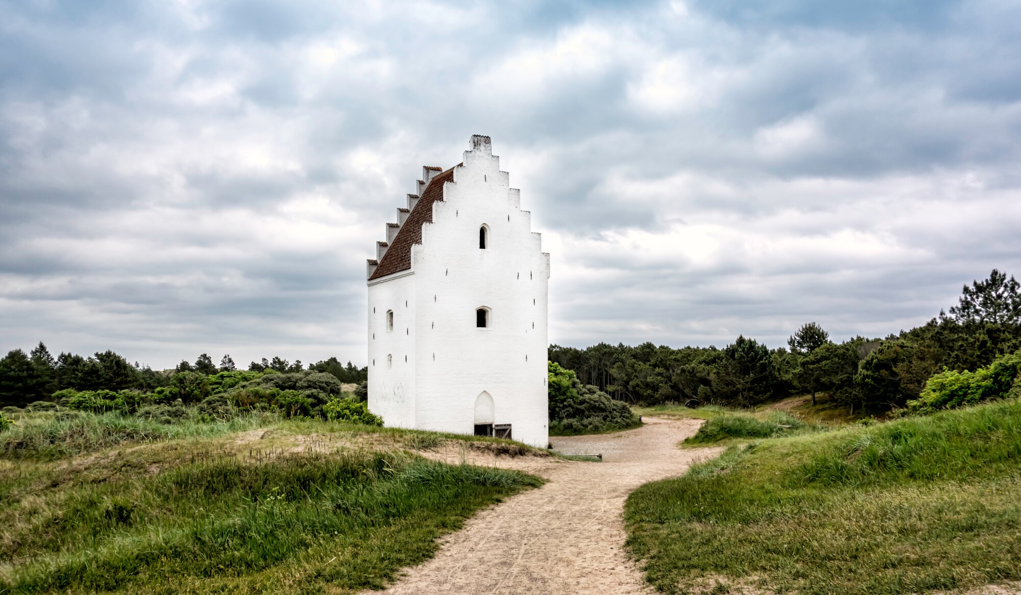 Die versandete Kirche bei Skagen vor bewölktem Himmel