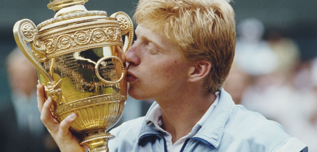 Der Tennisspieler Boris Becker küsst einen Pokal