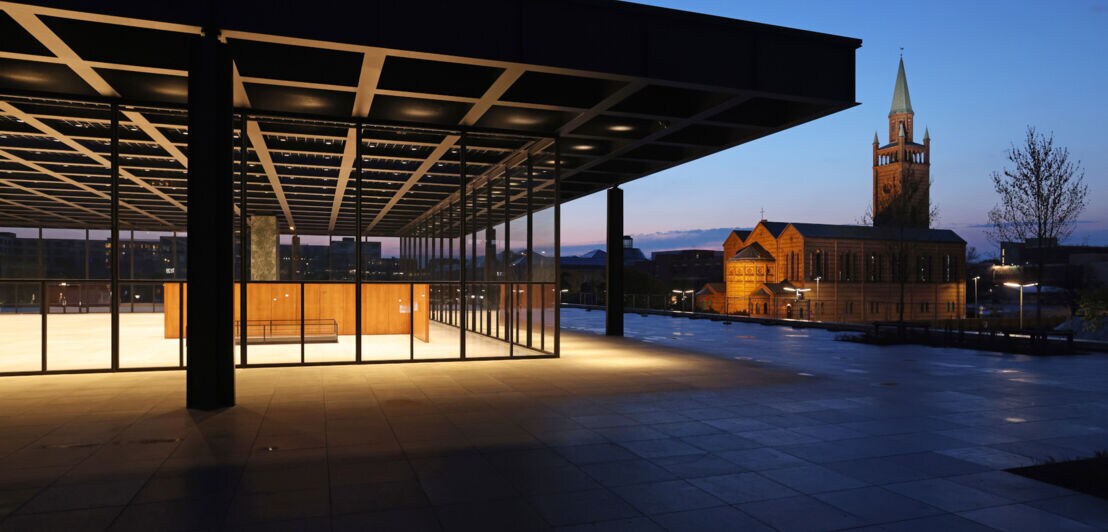 Die beleuchtete Neue Nationalgalerie mit Stahl-Glas-Fassade in Berlin bei Nacht