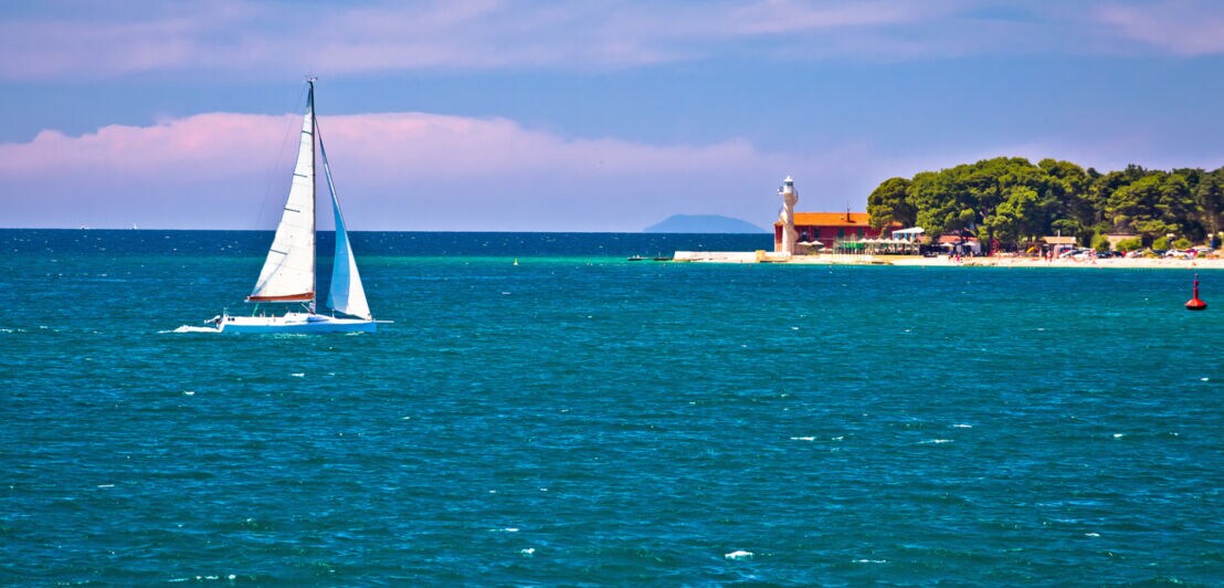 Ein kleines Segelboot steuert auf die Küste von Zadar in Kroatien zu