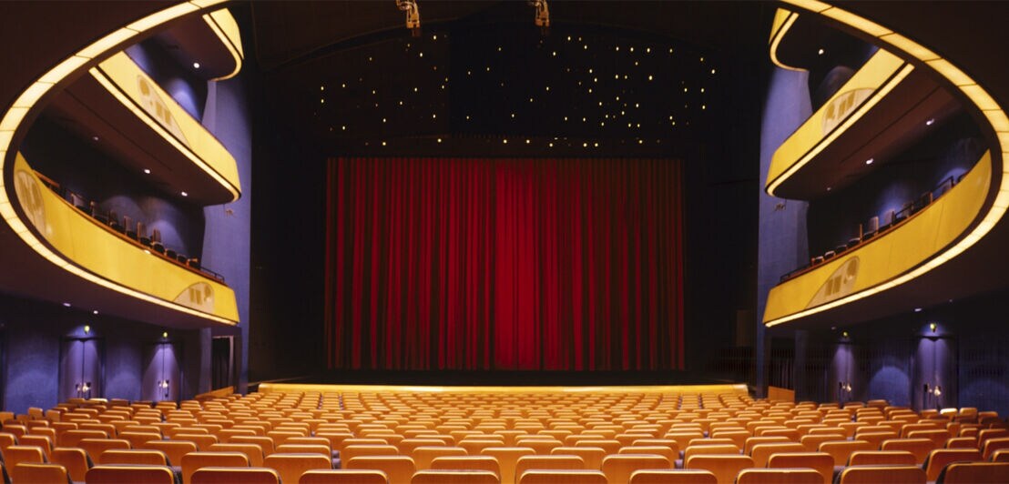 Innenansicht der festlich beleuchteten Oper Frankfurt mit Blick auf die Bühne.