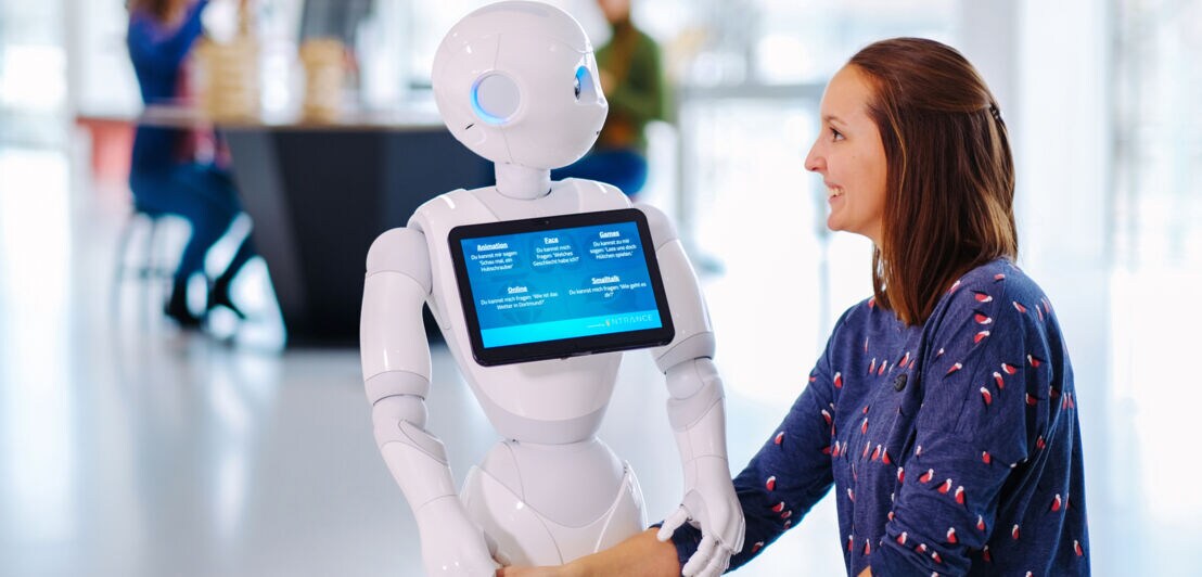 Eine junge Frau mit einem Roboter