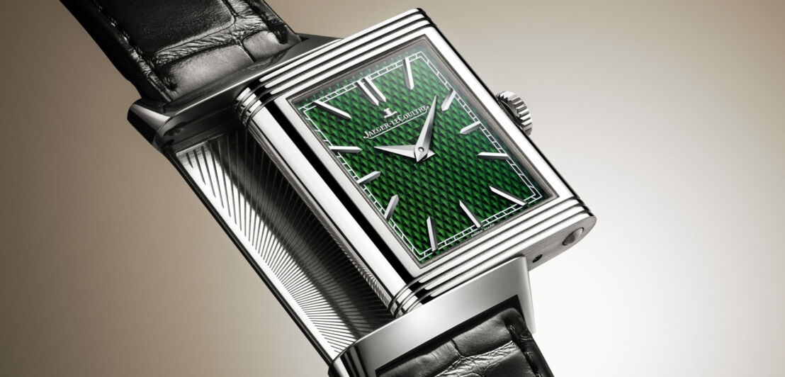 Close-up einer Uhr mit quadratischem Ziffernblatt in Grün.