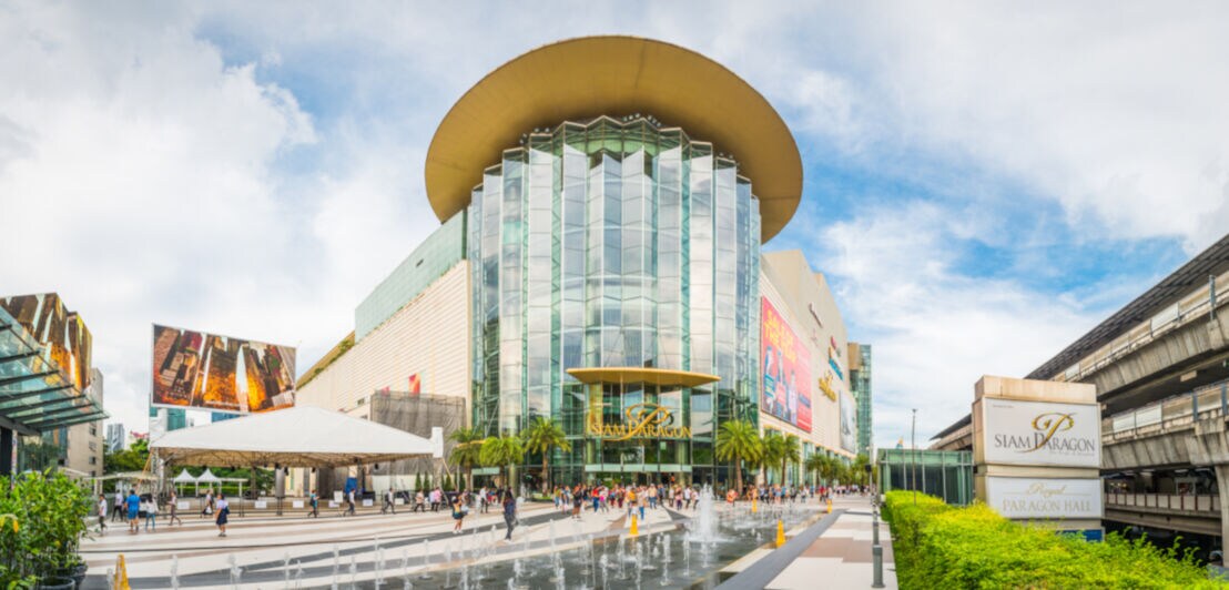 Frontaler Blick auf den gläsernen Eingangsbereich der Siam Paragon Shopping Mall
