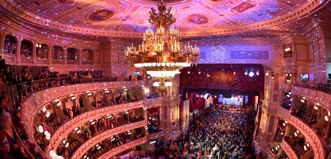 Publikum im atmosphärisch beleuchteten Zuschauersaal der Semperoper mit Tanzfläche auf der Bühne