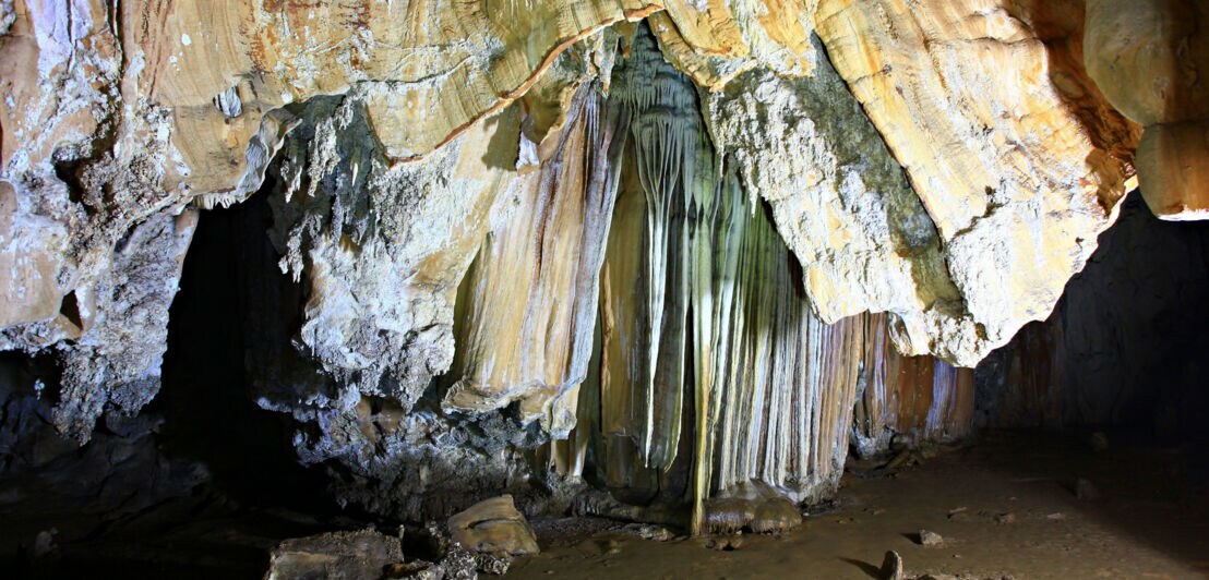 Stalaktiten hängen in der Coral Cave von der Decke