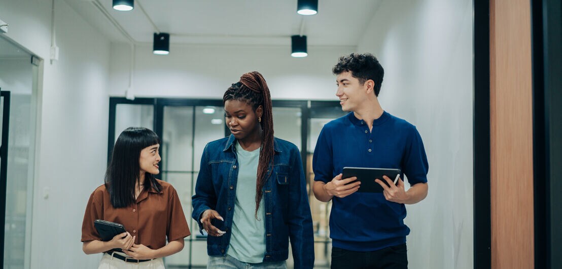 Eine Gruppe junger Erwachsener ist in ein Gespräch vertieft.