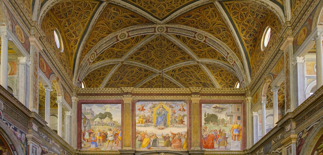 Blick auf bunte Wandmalereien in einer Kirche.